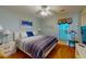Bright bedroom features a striped bedspread, hardwood floors, and beach-themed decor at 212 58Th Ave. N # 1C, North Myrtle Beach, SC 29582