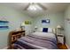 The bedroom showcases decorous paintings and a striped bedspread in a well-lit, comforting space at 212 58Th Ave. N # 1C, North Myrtle Beach, SC 29582
