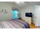 A bedroom features a striped bedspread, tv, and beach-themed decor at 212 58Th Ave. N # 1C, North Myrtle Beach, SC 29582