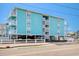 Charming aqua-colored condo complex featuring multiple balconies and a covered parking area with easy access to the beach at 212 58Th Ave. N # 1C, North Myrtle Beach, SC 29582