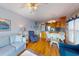 Open living room and dining area leading to kitchen with hardwood floors, sofa, and recliners at 212 58Th Ave. N # 1C, North Myrtle Beach, SC 29582
