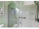A clean shower with a glass door, handrails, and a built-in seat at 212 58Th Ave. N # 1C, North Myrtle Beach, SC 29582