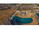 Breathtaking aerial view of the estate with a serene pond and fountain, promising privacy and picturesque scenery at 2325 Highway 111, Little River, SC 29566