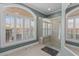 A modern bathroom features a large shower, wood tile floor, and a window with natural light at 2325 Highway 111, Little River, SC 29566