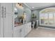 Elegant bathroom with double vanity, decorative mirrors, and ample natural light at 2325 Highway 111, Little River, SC 29566