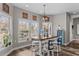 Cozy dining area featuring a wooden table, stools, decorative lighting, and ample natural light at 2325 Highway 111, Little River, SC 29566