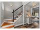 Elegant foyer with hardwood stairs, stylish decor, and a glimpse into the adjacent living space at 2325 Highway 111, Little River, SC 29566