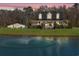 Stunning exterior view of the home featuring a picturesque pond with fountain and spacious lawns, perfect for entertaining at 2325 Highway 111, Little River, SC 29566