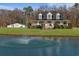 Charming two-story home with a sprawling lawn, beautiful pond with fountain, and white picket fence at 2325 Highway 111, Little River, SC 29566