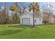 Detached garage with a convenient roll-up door, ideal for parking and storage, surrounded by lush greenery at 2325 Highway 111, Little River, SC 29566
