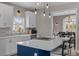 Bright, modern kitchen with white cabinets, a center island, and open views to the dining area at 2325 Highway 111, Little River, SC 29566