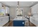 Modern kitchen with a large island, white cabinetry, and views into the dining area at 2325 Highway 111, Little River, SC 29566