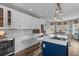 Spacious kitchen with white cabinets, a large island with seating, and stainless steel appliances at 2325 Highway 111, Little River, SC 29566