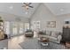 Open living room featuring vaulted ceilings, plush seating, and access to the outdoor area at 2325 Highway 111, Little River, SC 29566