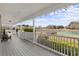 Relaxing covered porch with a view of the serene pond and fountain, perfect for enjoying the outdoors at 2325 Highway 111, Little River, SC 29566