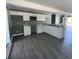 Modern kitchen featuring white cabinets and laminate flooring at 237 Charles Rd., Marion, SC 29571