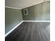 Large room with green walls and laminate flooring at 237 Charles Rd., Marion, SC 29571