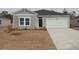 Charming single-story home with a well-manicured lawn and attached one car garage at 252 Warner Crossing Way, Loris, SC 29569