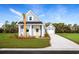 Charming coastal-style home with blue siding, a yellow door, and a well-manicured front yard at 2521 Rowyn St., Longs, SC 29568