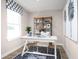 Bright home office featuring a white desk, stylish rug, and decorative shelving at 2521 Rowyn St., Longs, SC 29568