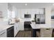 Bright kitchen featuring white cabinets, stainless appliances, and quartz countertops at 2521 Rowyn St., Longs, SC 29568