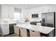 Modern kitchen with white cabinets, stainless steel appliances, and a quartz countertop island at 2521 Rowyn St., Longs, SC 29568
