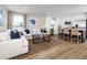 Open-concept living room and kitchen with hardwood floors and modern decor at 2521 Rowyn St., Longs, SC 29568