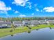 A serene aerial view of lakeside homes with lush green lawns and private swimming pools at 2526 Great Scott Dr., Myrtle Beach, SC 29579
