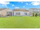 Expansive backyard with a lush lawn, white fence, and view of neighboring houses at 2526 Great Scott Dr., Myrtle Beach, SC 29579