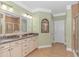 Bathroom featuring double vanity with granite countertop, decorative mirror and tiled floors at 2526 Great Scott Dr., Myrtle Beach, SC 29579