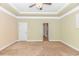 Large bedroom featuring neutral carpeting, crown molding, a ceiling fan, and doorway leading to the bathroom at 2526 Great Scott Dr., Myrtle Beach, SC 29579