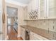 Charming butler's pantry with wine storage, glass cabinets, and granite countertops at 2526 Great Scott Dr., Myrtle Beach, SC 29579