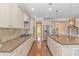 Modern eat-in kitchen with stainless steel appliances, granite countertops, and beautiful hardwood flooring at 2526 Great Scott Dr., Myrtle Beach, SC 29579