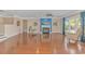 Open-concept living room with a fireplace, hardwood floors, large windows, and serene decor at 2526 Great Scott Dr., Myrtle Beach, SC 29579