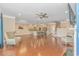 Open-concept living room with hardwood flooring and view of kitchen with bar stool seating and dining area at 2526 Great Scott Dr., Myrtle Beach, SC 29579