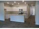Modern kitchen with granite countertops, island, stainless steel appliances, and gray floors at 260 Warner Crossing Way, Loris, SC 29569