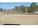 A large undeveloped lot in a community with mature trees at 260 Warner Crossing Way, Loris, SC 29569
