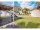Exterior backyard featuring a patio, shed, staircase, green grass, and blue skies at 2602 Perrin Dr., North Myrtle Beach, SC 29582