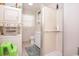 Functional bathroom with a washer/dryer, shower stall, and toilet with small vanity and shelving at 2602 Perrin Dr., North Myrtle Beach, SC 29582