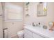 Modest bathroom featuring a white vanity and toilet with a mirrored medicine cabinet and window at 2602 Perrin Dr., North Myrtle Beach, SC 29582
