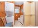 Bathroom with washer and dryer, shower, wood paneling, and neutral flooring at 2602 Perrin Dr., North Myrtle Beach, SC 29582
