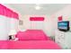 Vibrant bedroom featuring two beds, a dresser, and colorful pink accents at 2602 Perrin Dr., North Myrtle Beach, SC 29582