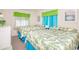 Bright bedroom features two beds with palm-leaf bedding and colorful sheer curtains at 2602 Perrin Dr., North Myrtle Beach, SC 29582