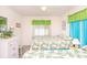Inviting bedroom with two beds, palm-leaf bedding, and bright sheer curtains at 2602 Perrin Dr., North Myrtle Beach, SC 29582