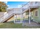 Exterior of the home featuring a staircase leading to an upper level with a green grass and a small shed at 2602 Perrin Dr., North Myrtle Beach, SC 29582