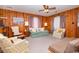 Seating area of living room with plush carpeting and wood paneled walls at 2602 Perrin Dr., North Myrtle Beach, SC 29582