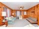 Spacious living room featuring wood paneled walls, comfortable seating, and natural light at 2602 Perrin Dr., North Myrtle Beach, SC 29582