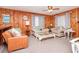 Relaxing living room with wood paneling, neutral furniture, and bright natural light at 2602 Perrin Dr., North Myrtle Beach, SC 29582
