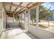 Screened-in porch with cushioned seating and views of the street and surrounding trees at 2602 Perrin Dr., North Myrtle Beach, SC 29582