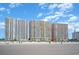 Beachfront view of the property's multiple buildings under blue skies, with beach access at 2701 S Ocean Blvd. # 1908, North Myrtle Beach, SC 29582
